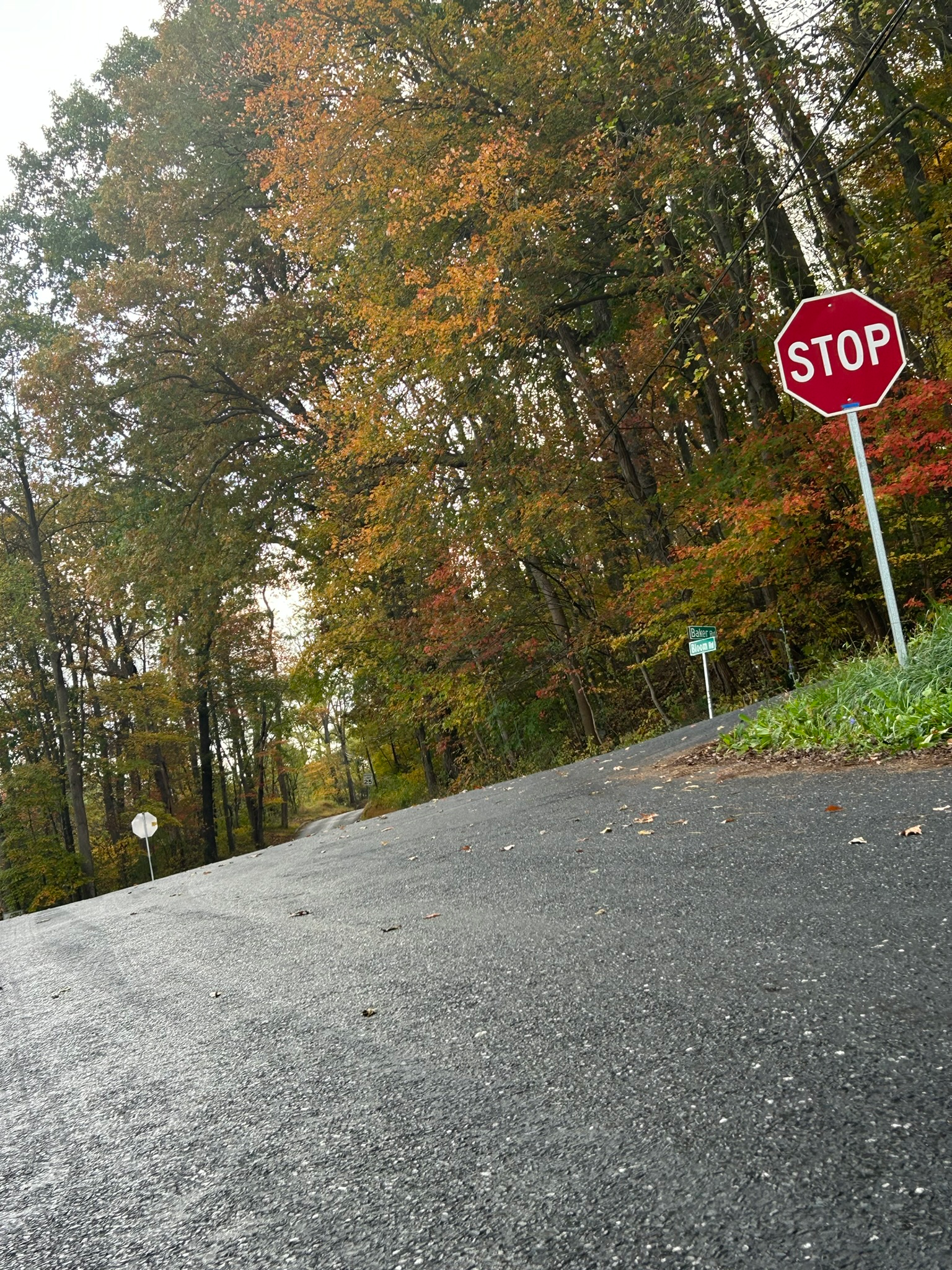 Stop sign at the top of a steep hill